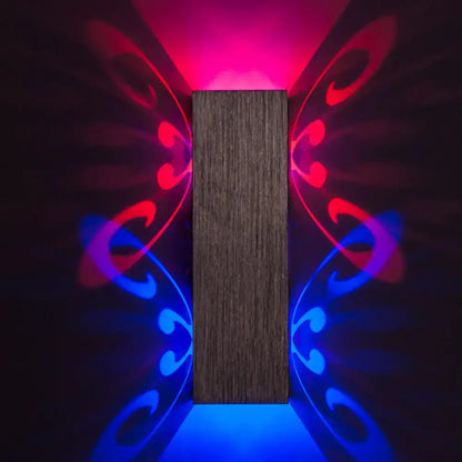 Modern brushed silver butterfly design dark wood wall sconce with bulb base casting red and blue light patterns