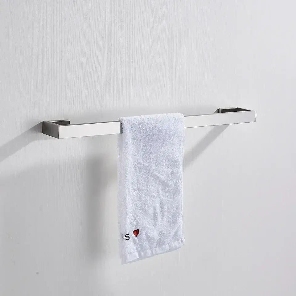 Silver brushed stainless steel towel rack with white terry cloth towel featuring red heart and black s in modern bath hardware set
