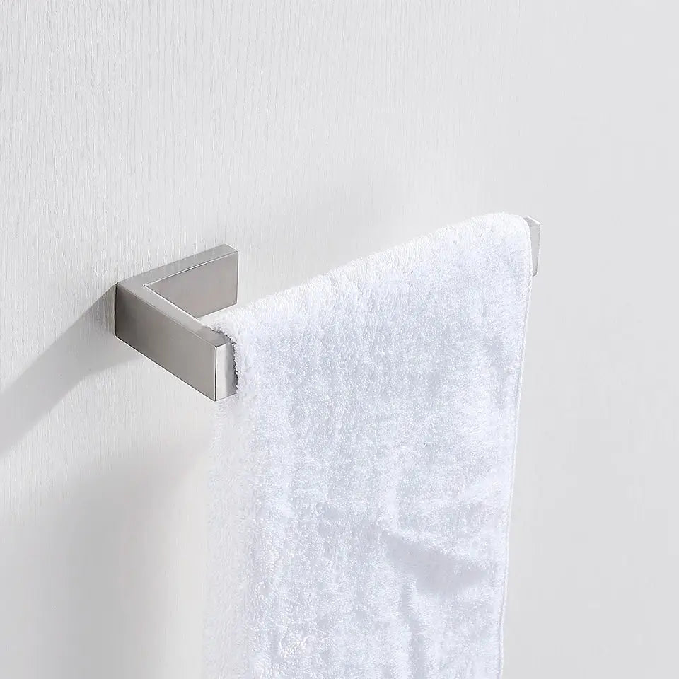 A modern brushed stainless steel bath hardware set features a sleek silver towel rack holding a plush white towel
