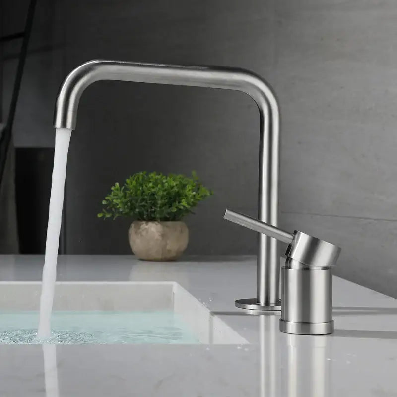 Modern brushed stainless steel kitchen faucet with curved spout and minimalist design in brushed stainless finish