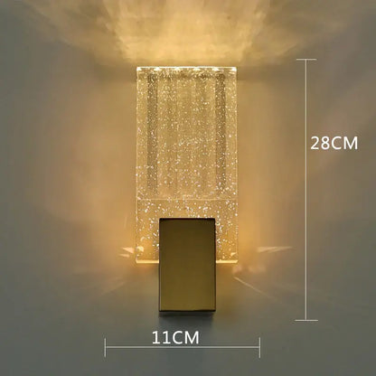 A modern rectangular wall sconce with a golden base and decorbites bubble crystal LED body for bathroom mirrors