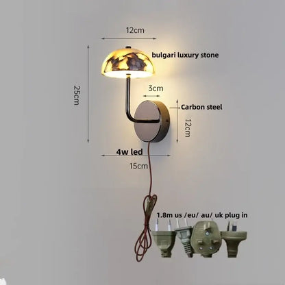 A sleek modern wall light with a dome bulgari stone top and curved carbon steel arm for bedroom decorbites bulgari stone