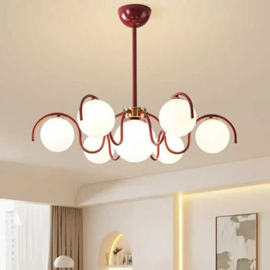 Modern burgundy pendant light with rounded frosted glass globe shades in a sleek design for dining room use