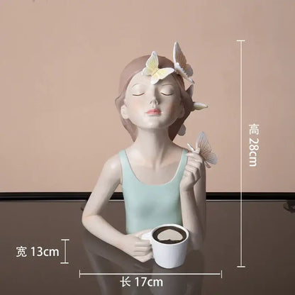A serene light blue butterfly girl resin sculpture holding a white mug for modern living room decor