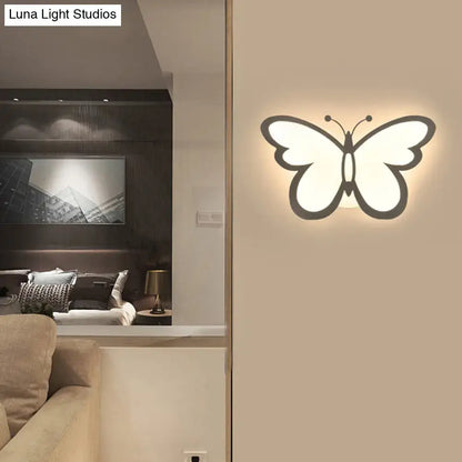 A modern butterfly led wall lamp with a glowing white acrylic center and dark gray outline highlighting maximum bulb wattage