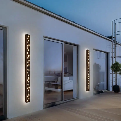 Modern black butterfly pattern led outdoor wall sconce with warm glowing vertical lights by decorbites