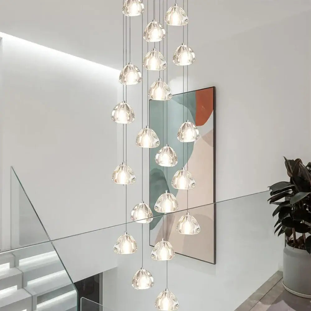 Modern cascading crystal ball chandelier with clear teardrop glass pendants suspended on metallic chains by decorbites crystal ball