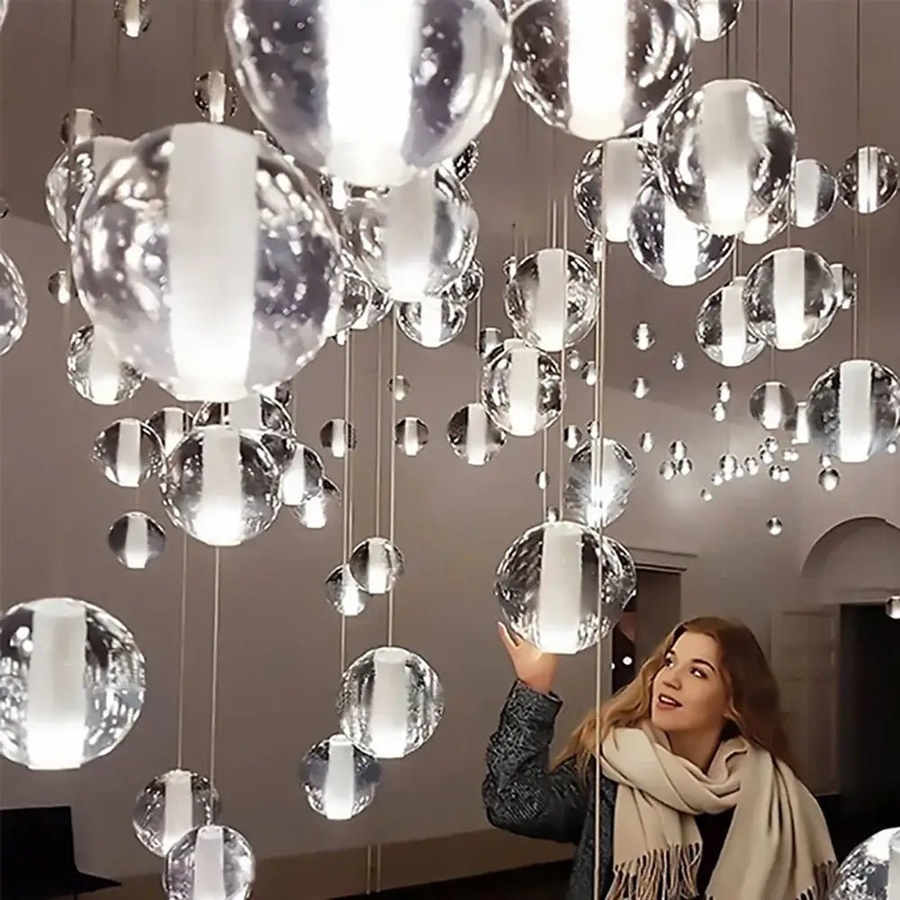 A modern cascading crystal ball led pendant light with reflective glass orbs for elegant living room decorbites pendant light