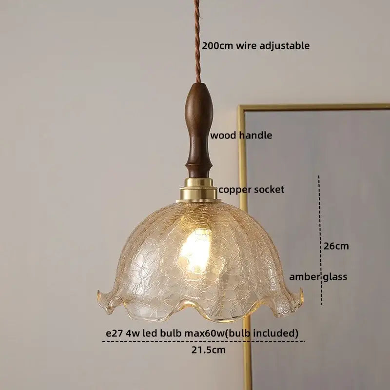 A warm amber decorbites ceramic led pendant light with crackled finish and wooden handle for dining room decor