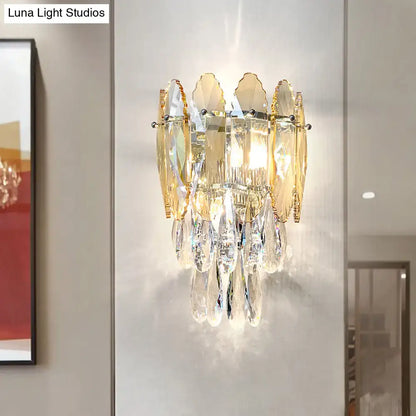 Modern champagne smoke gray crystal wall sconce with gold-toned led light and cascading clear and amber glass pieces