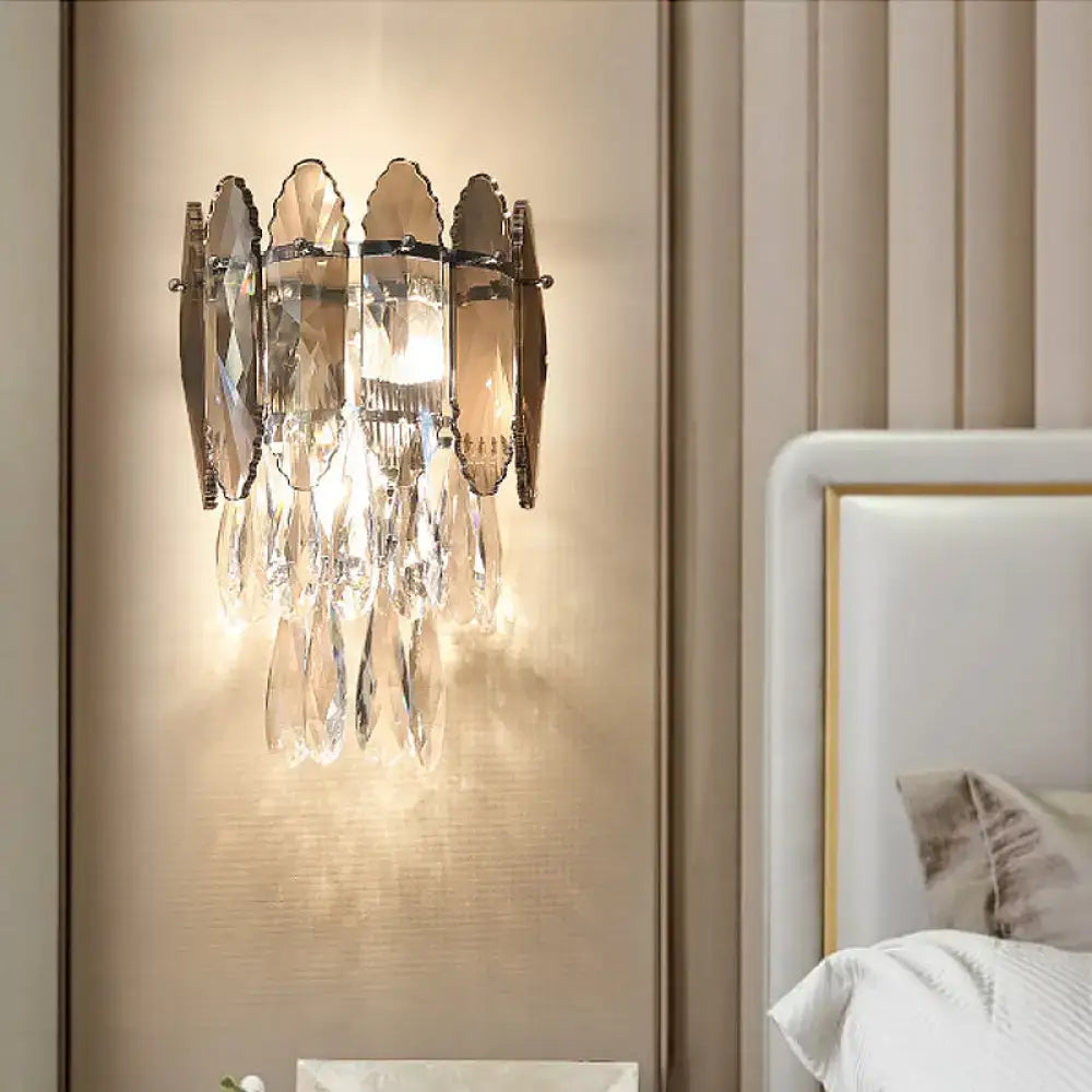 Elegant modern champagne smoke gray crystal wall sconce with metallic frame and cascading teardrop crystals for bedroom led light