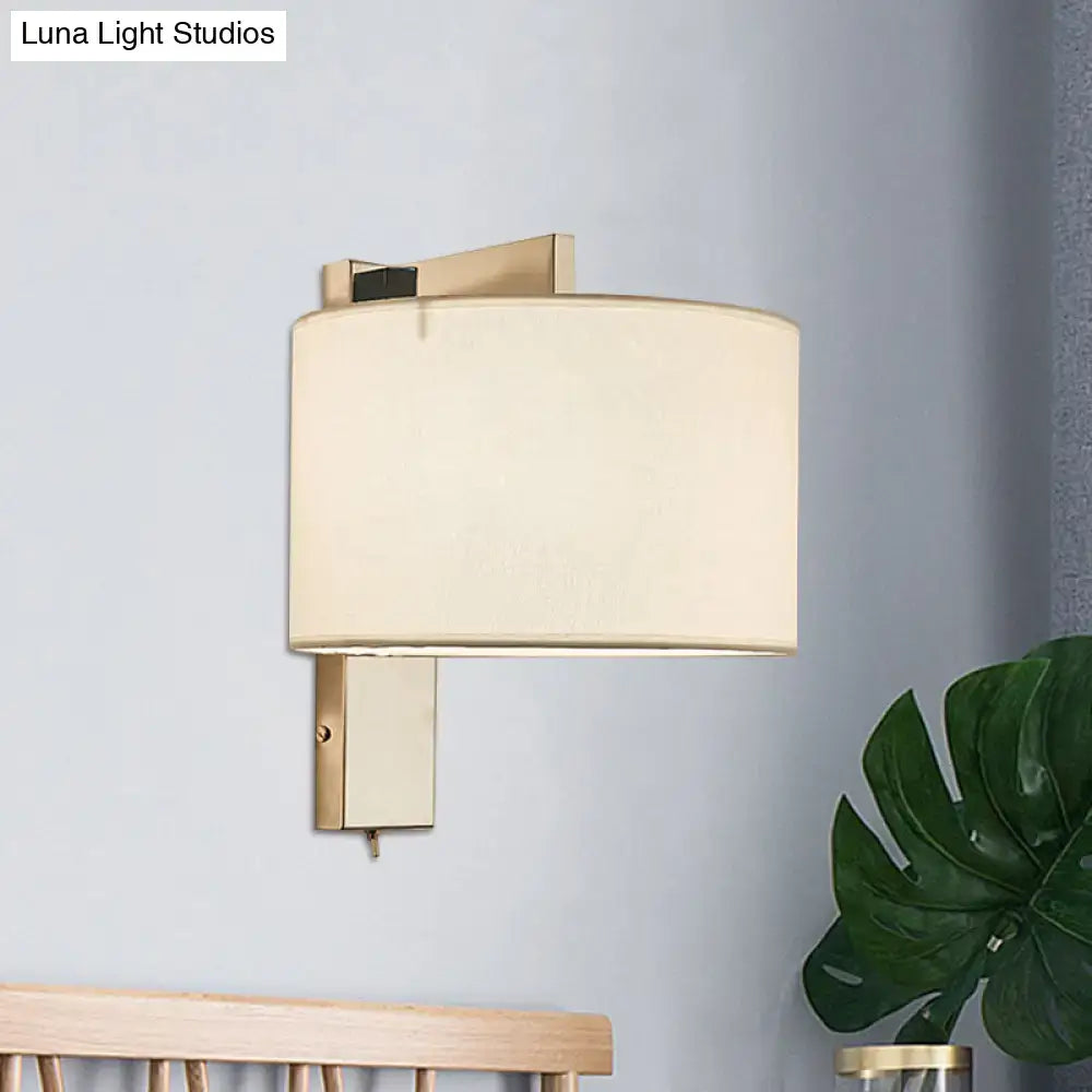 Modern gold-finished wall sconce with cylindrical off-white fabric shade for white black drum wall sconce bedroom light