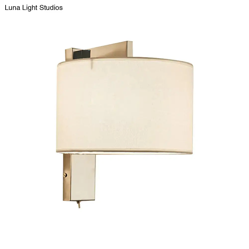 Modern brushed brass wall sconce with cylindrical off-white fabric shade for white black drum wall sconce lighting