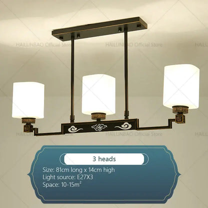 Bronze-finished modern chinese style chandelier pendant light with three white glass shades and ornate cloud motifs