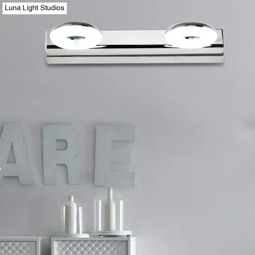 Modern chrome 2 head wall lighting fixture with circular softly glowing bulbs for bathroom wall installation