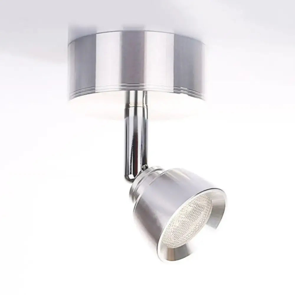 Modern chrome adjustable spotlight wall sconce with metal shade and sleek cylindrical design providing white light for bedroom
