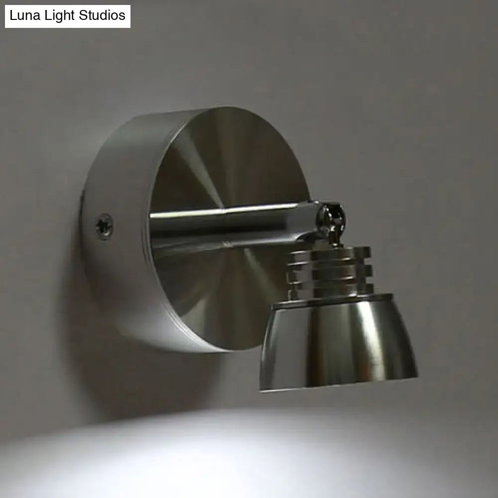 Modern chrome adjustable spotlight wall sconce with brushed stainless steel metal shade emitting warm white light