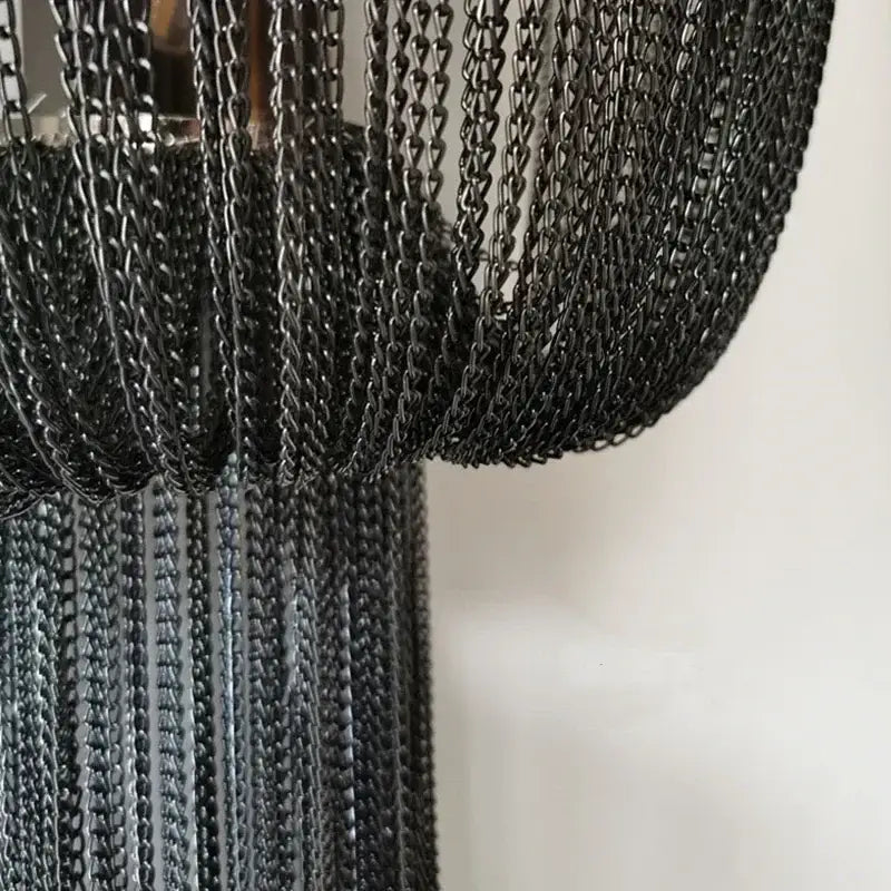 Black aluminum chain sconce with cascading textured curtain design for modern bedroom wall lighting