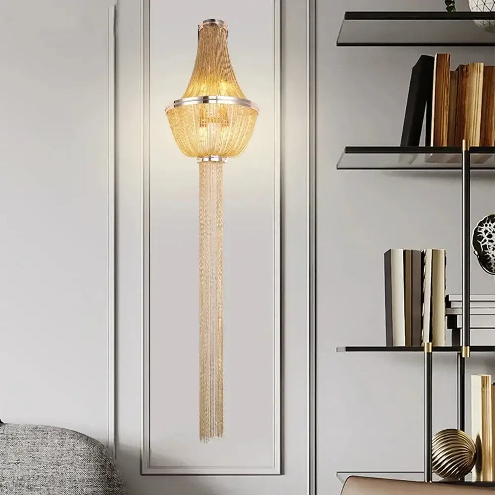 Modern chrome aluminum chain sconce with golden chain-link cascading fringe and sleek metallic frame for bedroom use