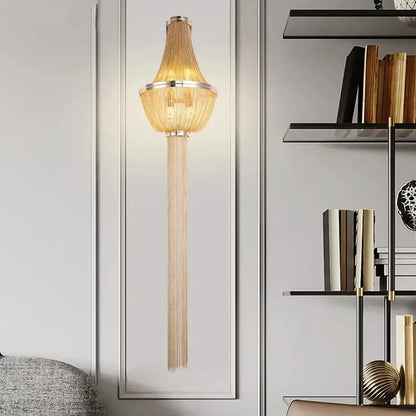 Modern chrome aluminum chain sconce with golden chain-link cascading fringe and sleek metallic frame for bedroom use