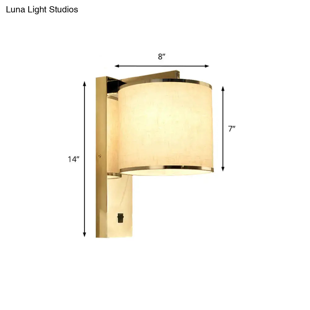 Gold-finished living room wall sconce with cylindrical off-white fabric shade and metallic trim modern led lighting