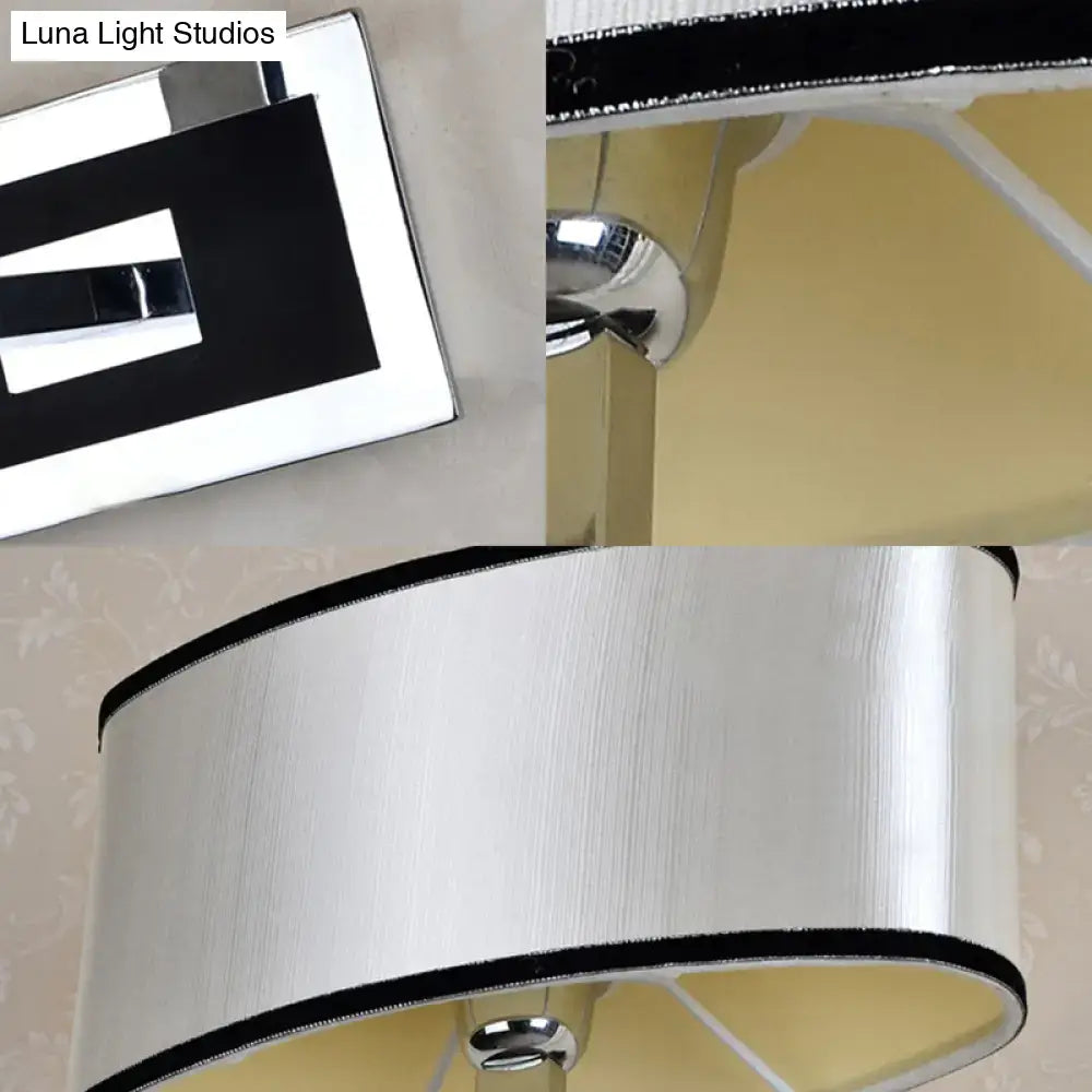 Modern chrome and beige oval wall sconce with a silver-finished table lamp and brushed metal shade with black trim