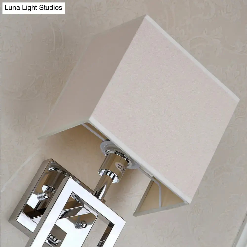 Modern chrome square sconce light with a white fabric shade wall lamp for bedroom lighting