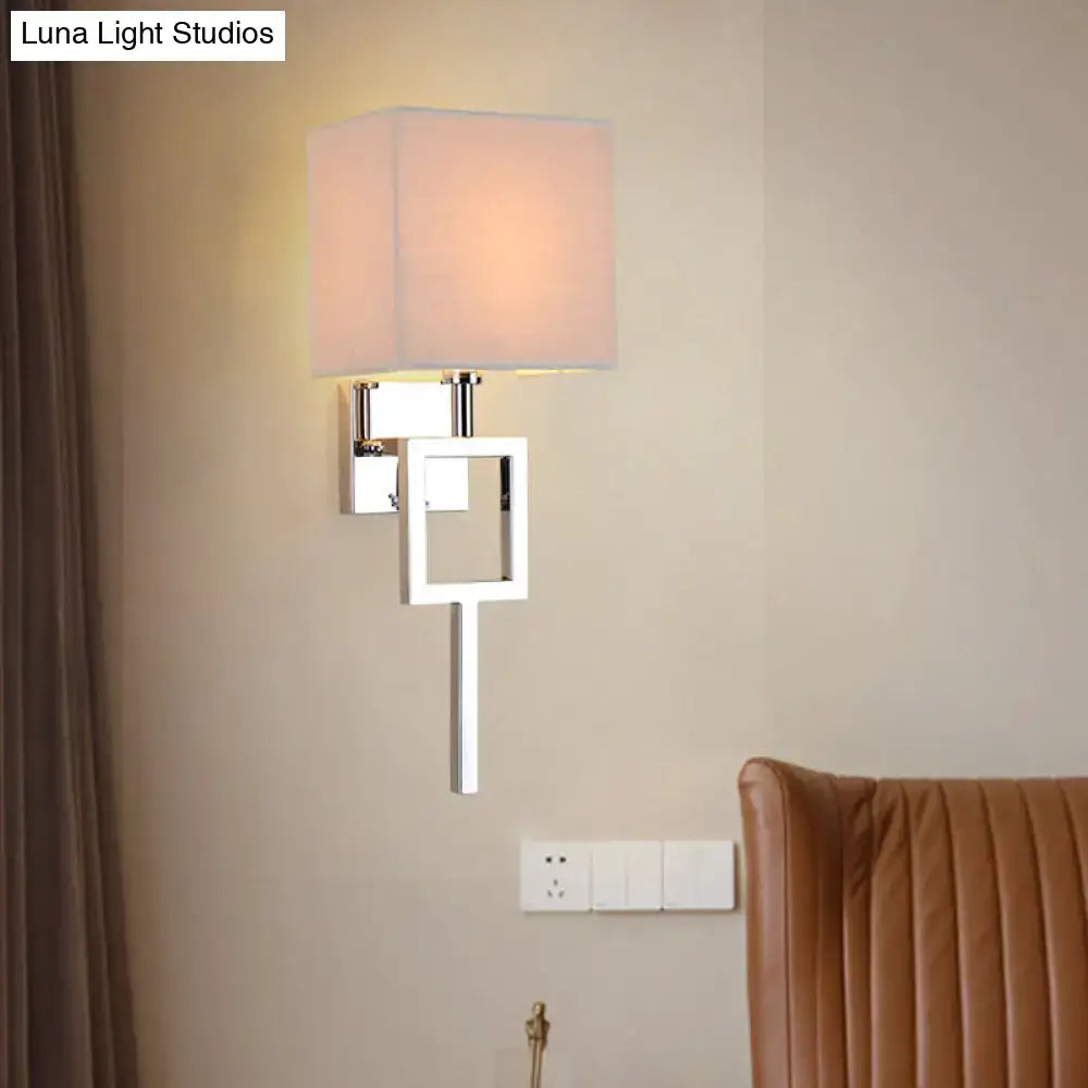 Modern chrome and beige square sconce light with fabric shade is a sleek wall lamp for bedroom use