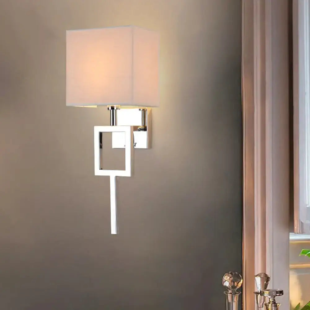 Modern chrome and beige square sconce light with off-white fabric shade and geometric metal frame wall lamp
