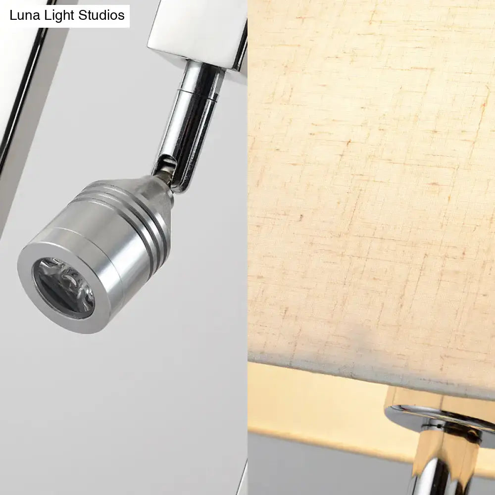 Modern chrome and beige wall mount light sconce with adjustable cylindrical spotlight featuring concentric ridges