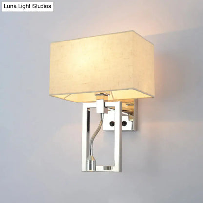 Modern chrome and beige wall mount light sconce with rectangular fabric shade and adjustable gooseneck spotlight for bedroom