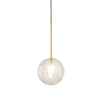 A modern pendant light with a clear glass globe, gold-toned metal rod, and black cord for kitchen lighting
