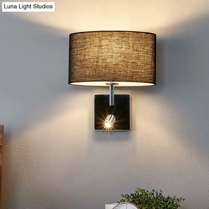 Modern chrome and brown fabric wall sconce with adjustable spotlight and metal fixture featuring textured beige shade