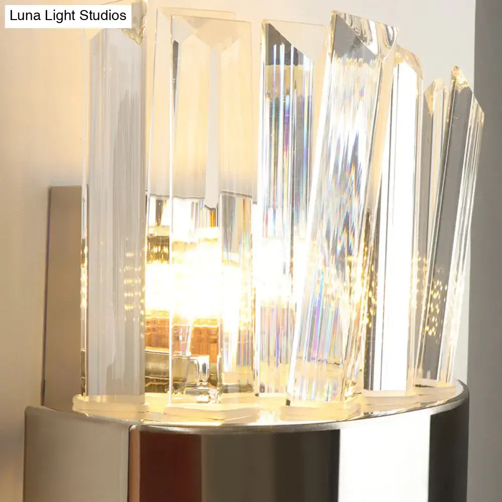 Modern chrome and clear crystal wall lamp with crystal-faceted design and polished chrome base for bedroom use