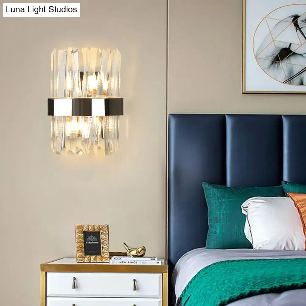 Modern chrome and clear crystal wall lamp with vertical facets and sleek black metal band for bedroom use
