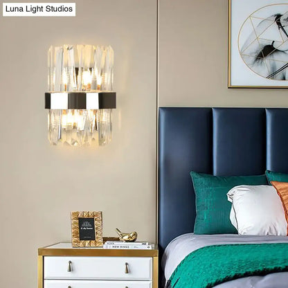 Modern chrome and clear crystal wall lamp with vertical facets and sleek black metal band for bedroom use