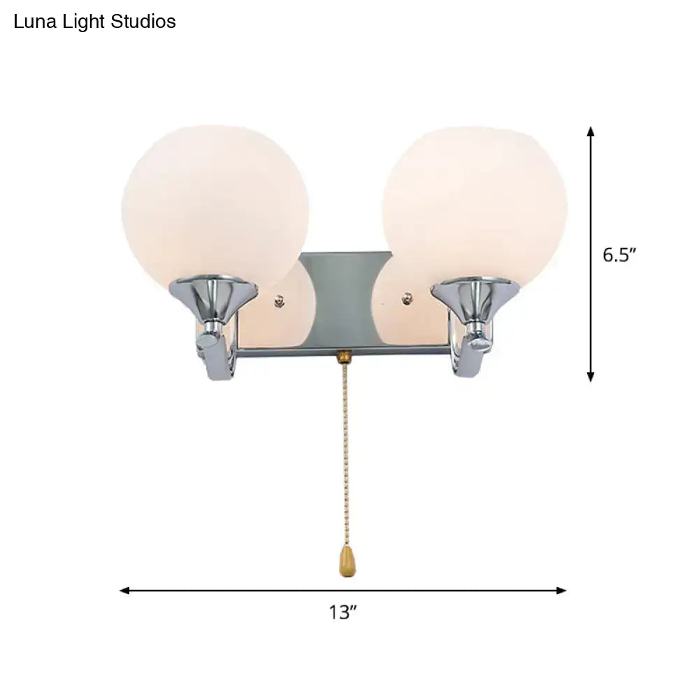 Modern chrome and cream glass wall light with two frosted globe shades and brass pull chain for 220v-240v 110v-120v use