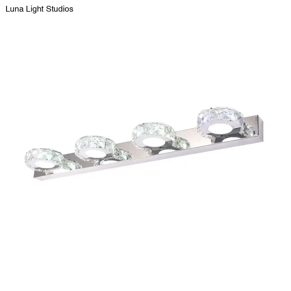 Modern chrome and gold crystal vanity sconce with three crystal-encrusted circular bulbs for bathroom lighting