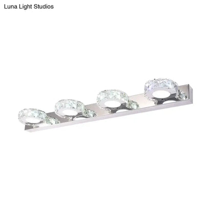 Modern chrome and gold crystal vanity sconce with three crystal-encrusted circular bulbs for bathroom lighting