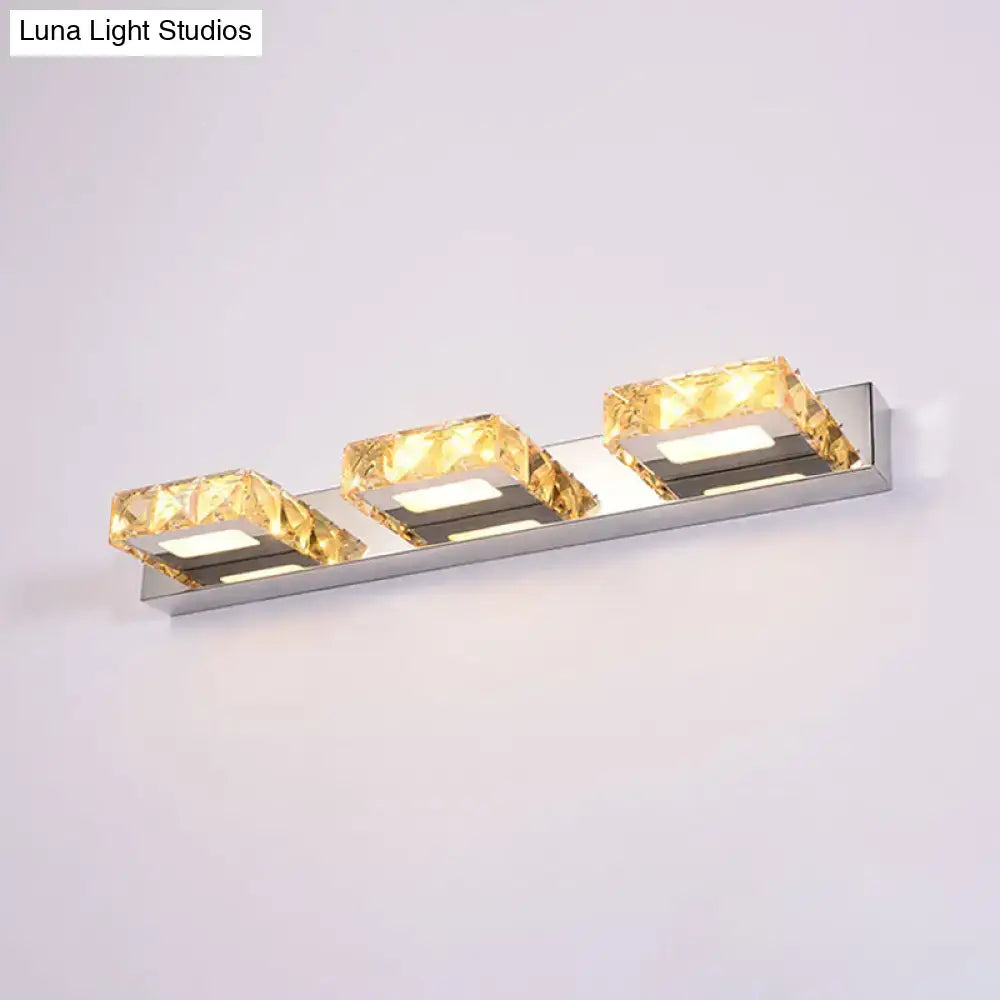 Modern chrome and gold crystal vanity sconce with polished stainless steel frame and faceted crystal vanity accents