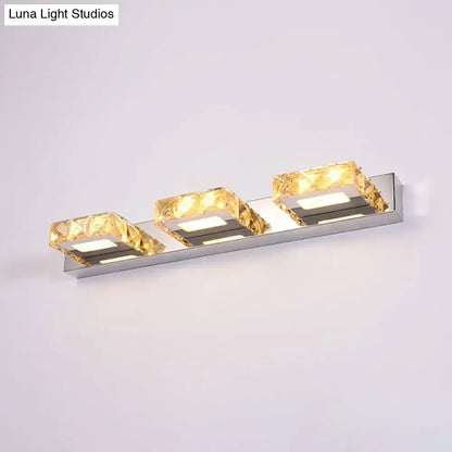 Modern chrome and gold crystal vanity sconce with polished stainless steel frame and faceted crystal vanity accents