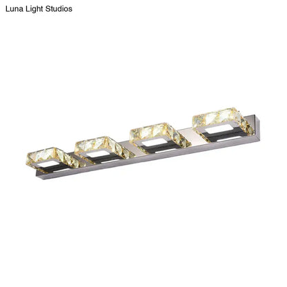 Modern chrome and gold crystal vanity sconce with four faceted golden cubes for elegant bathroom lighting