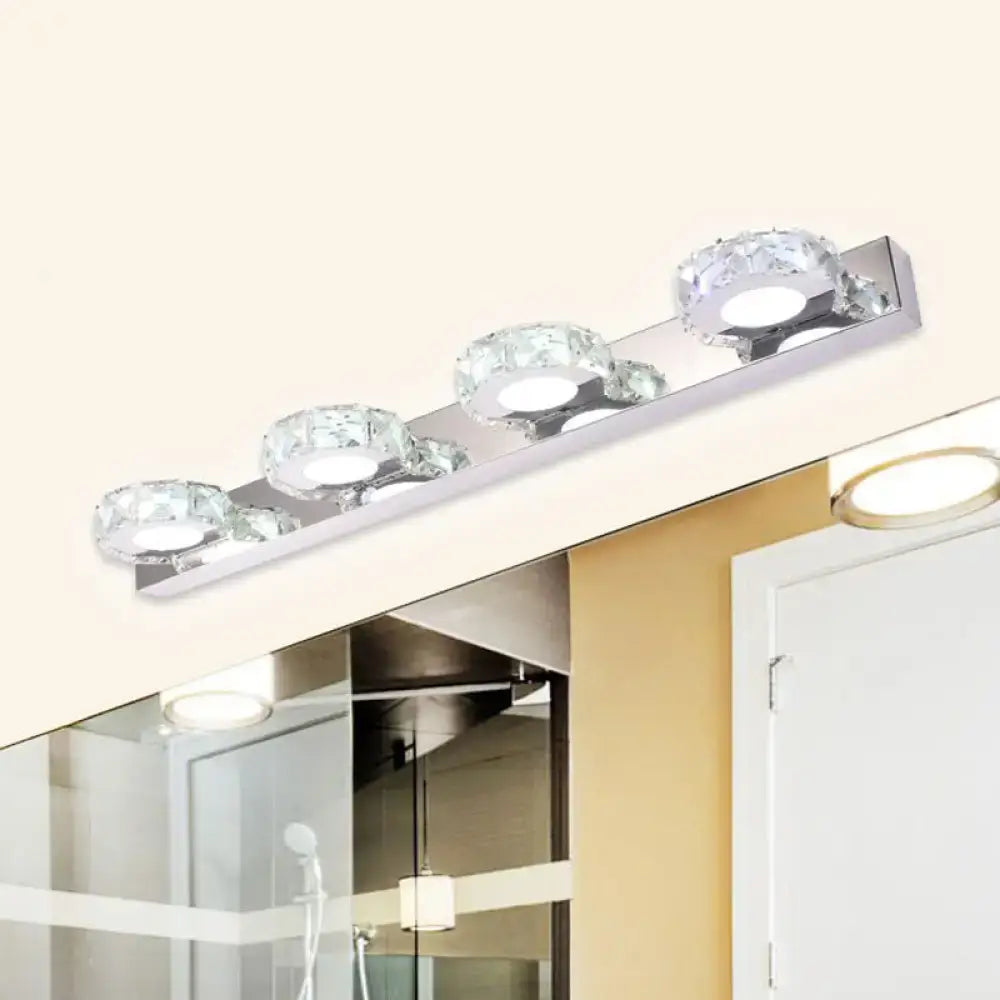 Modern chrome and gold crystal vanity sconce with four faceted crystal globe shades for bathroom lighting