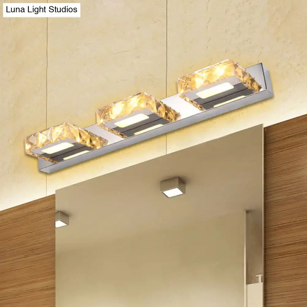 Modern chrome and gold crystal vanity sconce with three golden crystal accents and sleek stainless steel finish