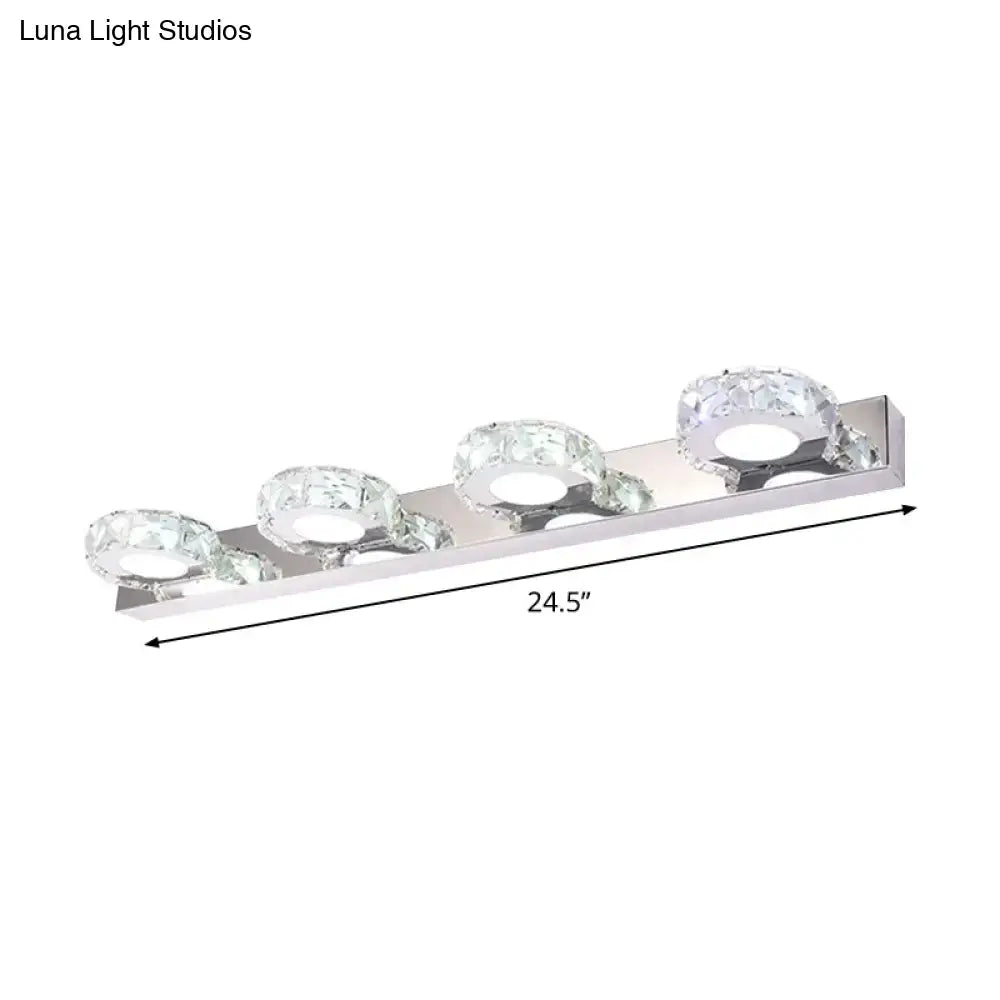 Modern chrome and gold crystal vanity sconce with silver chrome finish and three crystal-encrusted circular bulbs