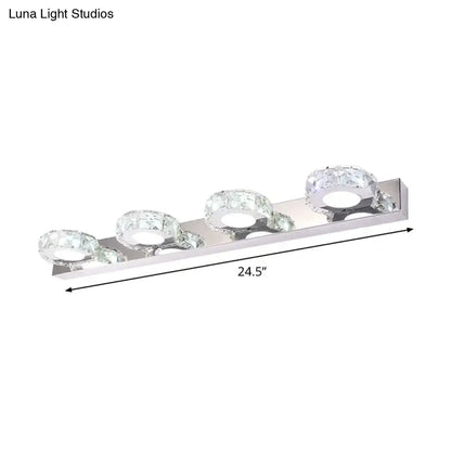Modern chrome and gold crystal vanity sconce with silver chrome finish and three crystal-encrusted circular bulbs