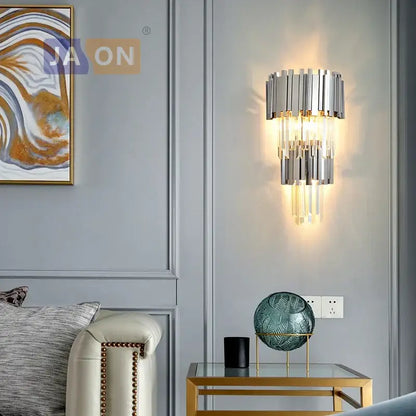 Modern chrome and gold decorbites crystal clear led wall sconce with cascading crystal rods emitting warm glow for bedroom
