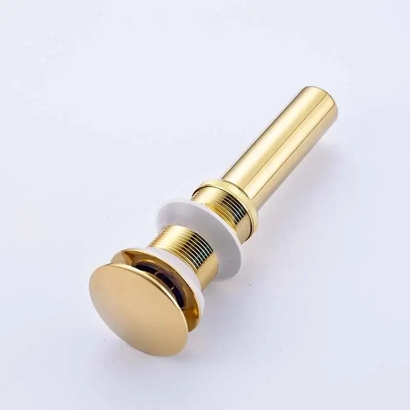 Modern chrome and gold bathroom sink pop up drain stopper with sleek cylindrical design and white ceramic sealing rings