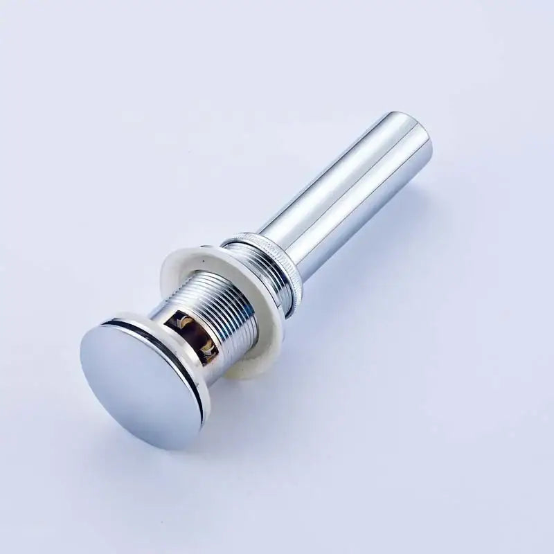 Modern chrome and gold bathroom sink pop up drain with sleek cylindrical design and threaded connection for bathroom sink pop
