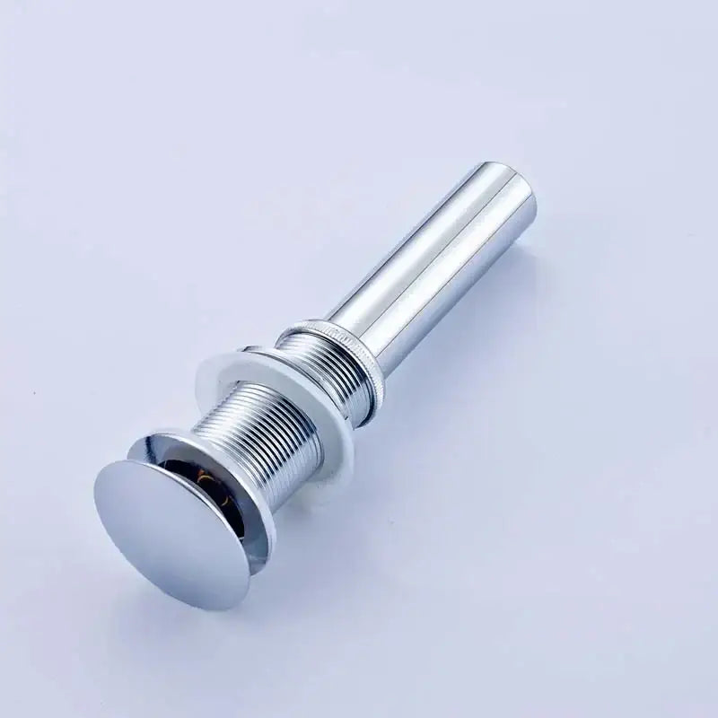 Modern chrome and gold bathroom sink pop up drain with sleek cylindrical metal design and threaded connection
